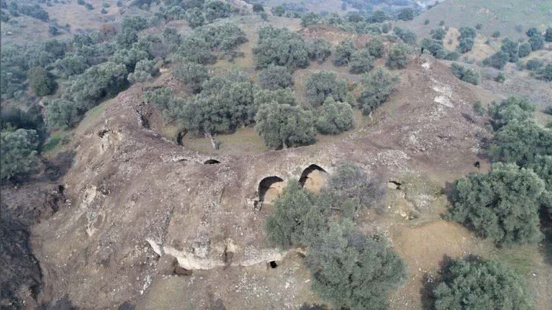 Fotografia aérea da arena, que ainda tem a maior parte de sua extensão escondida sob a colina