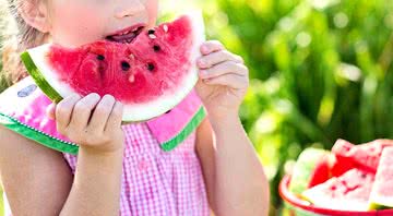 Criança comendo melancia - Imagem de Jill Wellington por Pixabay