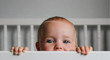 Um bebê observando dentro do berço - Getty Images