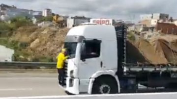 Trecho de vídeo em que é possível ver bolsonarista pendurado na frente do caminhão - Reprodução/Twitter