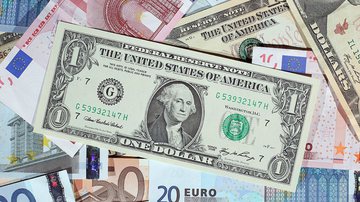 Cédulas de dólar e euro sobrepostas - Getty Images