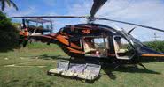 Fotografia do helicóptero que seria utilizado, ao lado das malas de dinheiro - Divulgação/Polícia Federal