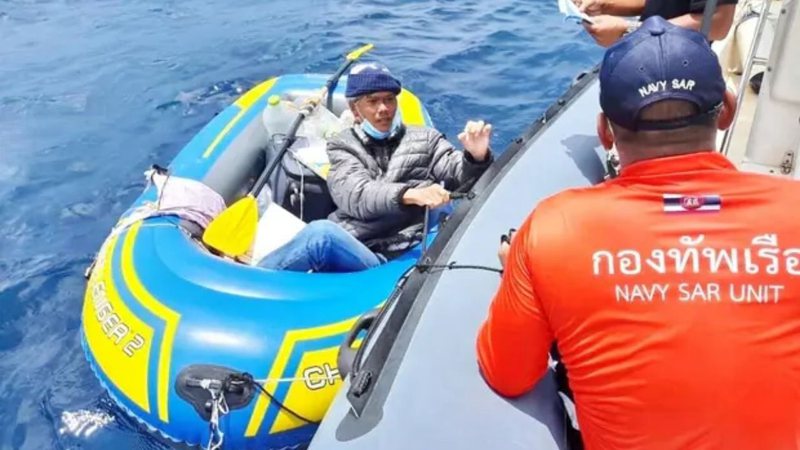 Homem sendo resgatado de bote na Tailândia